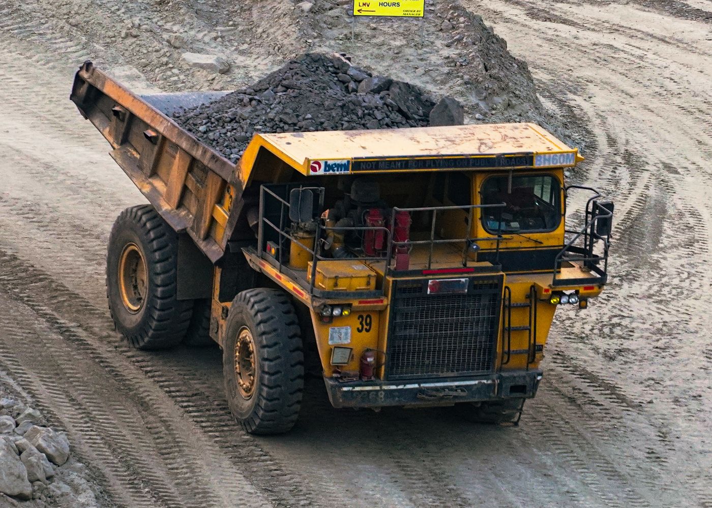Construction truck selection: mining truck at worksite. Illustrative stock photo.
